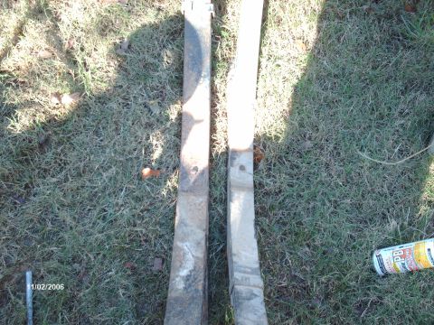 1990 Ford F-150 - Two leaf springs are shown on the grass, with a can of lubricant next to them.