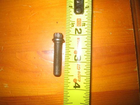 1979 Ford Bronco - A single bolt is measured against a yellow tape measure.