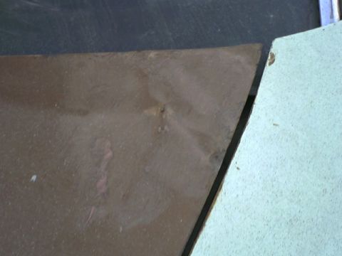 1973 Ford Ranchero - Detail of a rusty metal panel, possibly from a vehicle part or bodywork.