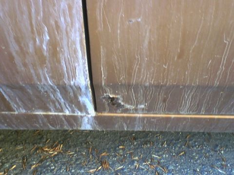 1973 Ford Ranchero - The lower section of a vehicle's door shows significant rust and discoloration from dirt or grime.