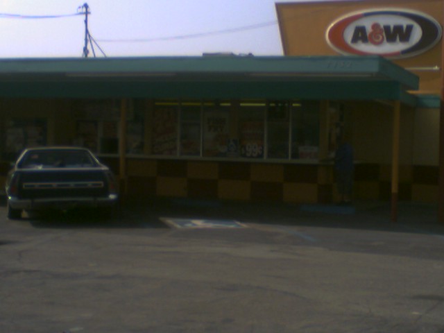 dark sedan parked in front of an A&W restaurant