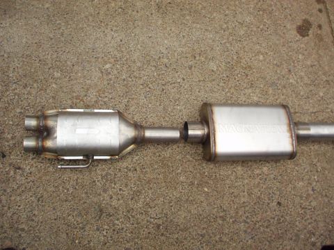 1994 Ford Bronco - A Magnaflow exhaust system part is shown laid out on a concrete surface.