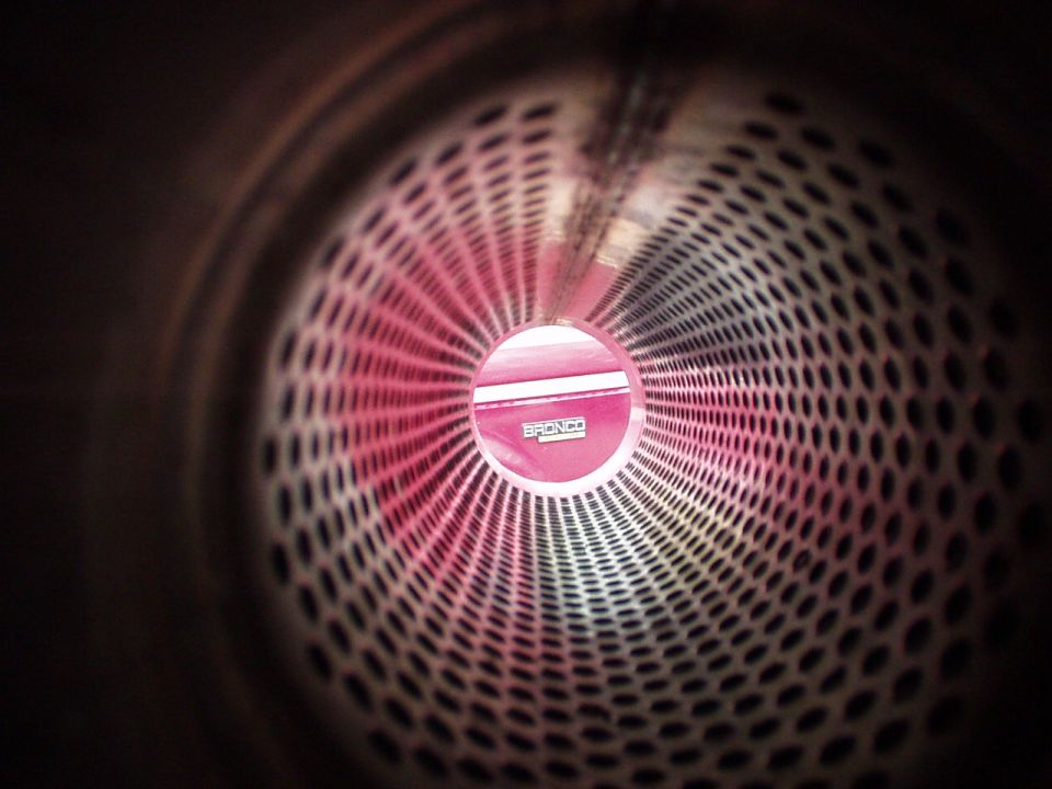 View through exhaust pipe showing a pink Bronco badge