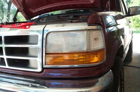 1996 Ford Bronco - Close-up of a 1996 Ford Bronco's front end, showing the grille and headlights.