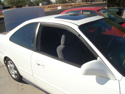 1997 Ford Probe - The 1997 Ford Probe is seen from the side with its hood open and a sunroof.