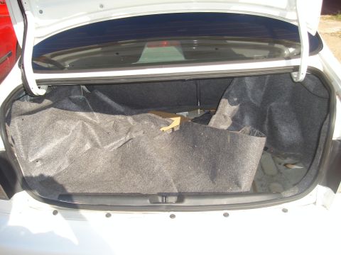 1997 Ford Probe - The interior of a car's trunk is shown with the lid open.