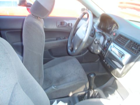 1997 Ford Probe - The interior of a car shows the driver's seat, dashboard, and center console.