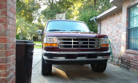 1996 Ford Bronco - Front view of a maroon 1996 Ford Bronco parked in a driveway.