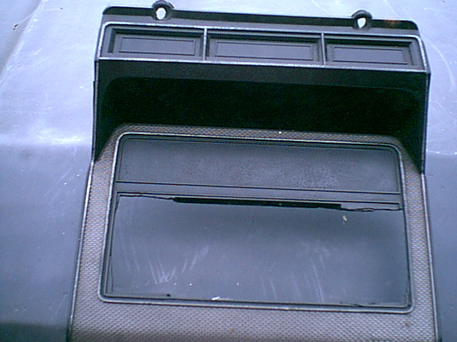 Here is the stock bezel. i am not too worried about chopping it up as you can see the PO did to install a radio. this is the front. I will cut to fit the top section of the bezel.