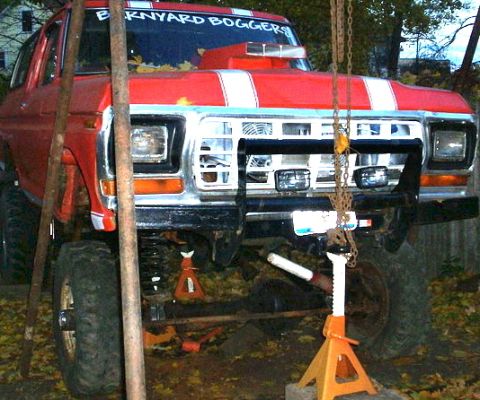 1978 Ford Bronco - Modified 1978 Ford Bronco lifted on jack stands, showing its front end and suspension.