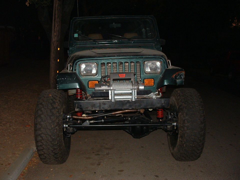 Green 1994 Jeep YJ front view with winch and large tires