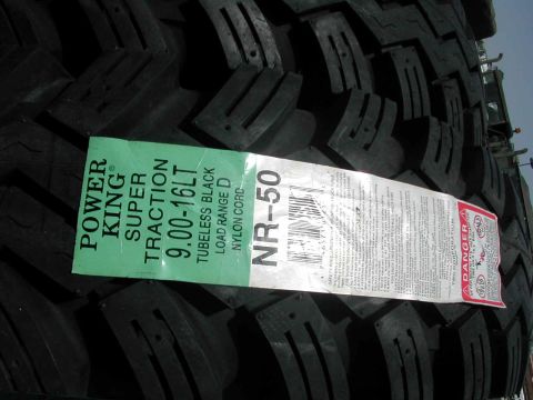 1989 Ford Bronco - A new Power King Super Traction tire is shown with its size and model information clearly visible on the label.
