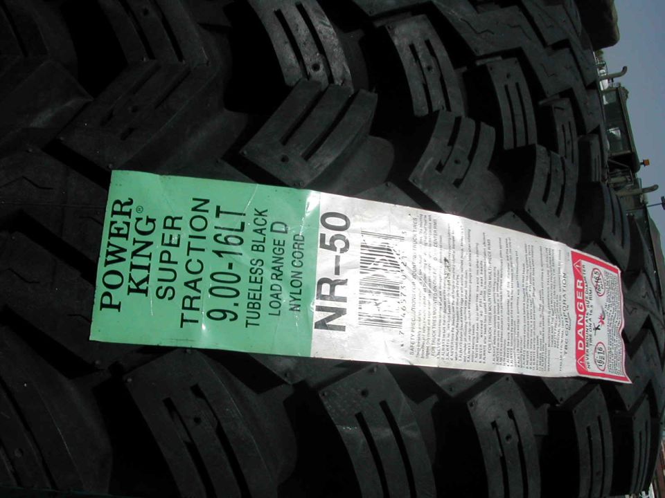 New Power King Super Traction tire with size 9.00-16LT and NR-50 model number on a green and white label