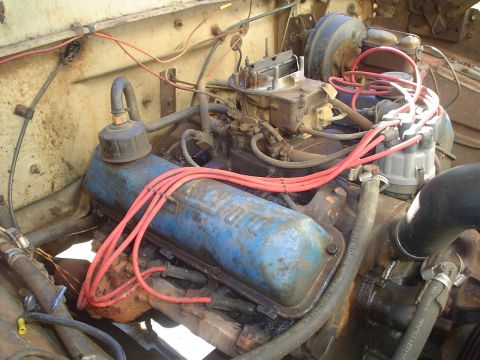 1967 Ford F-250 - Close-up of a 1967 Ford F-250 engine, showing the carburetor and spark plug wires.