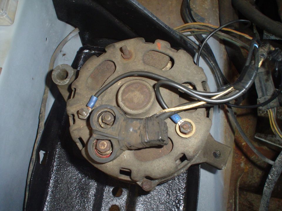 Close-up of an old alternator with wires connected