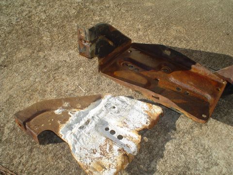 1967 Ford F-250 - These heavily rusted metal components are not identifiable as a 1967 Ford F-250 without further context or clearer evidence.