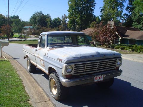 1967 Ford F-250 - This 1967 Ford F-250 pickup truck is seen from the front, showing its light blue paint and grille.