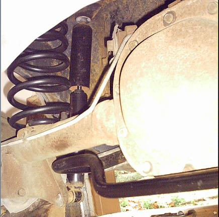 1985 Ford Crown Victoria LTD - Close-up view of a vehicle's rear suspension system and differential assembly.