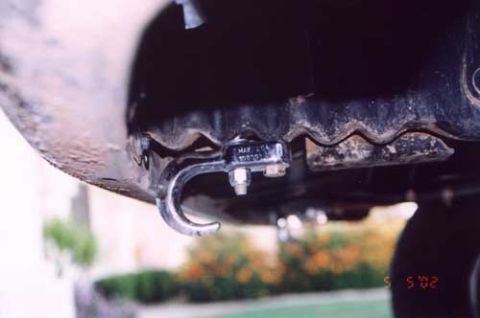 1993 Ford Bronco - A tow hook is mounted to the underside of a vehicle, with a tag indicating its specifications.