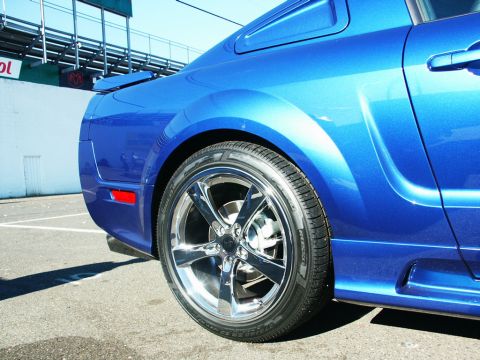 2001 Mercury Grand Marquis - A blue sports coupe is parked on asphalt, with a spoiler and custom rims visible.