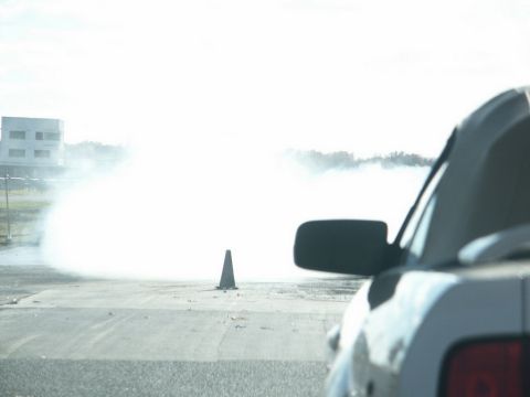 2001 Mercury Grand Marquis - View from inside a vehicle looking out at smoke and a traffic cone on a track.