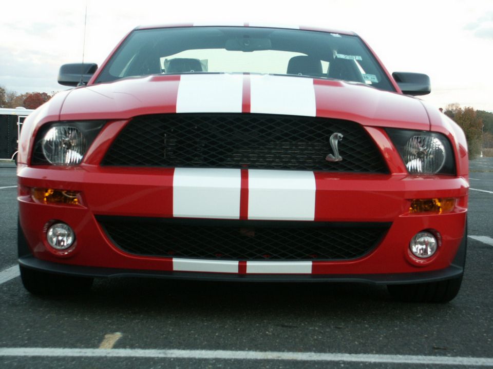 Red 2007 Ford Mustang Shelby GT500 front view with white stripes