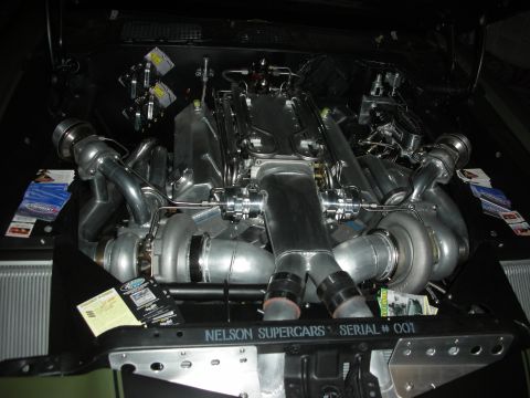 1998 Ford Crown Victoria - polished twin-turbo V-engine fills a dark engine bay with a panel reading Nelson Supercars Serial #001 across the front.