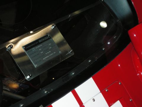 1998 Ford Crown Victoria - stainless 'Powered by Roush' engine spec plate riveted into a red car panel with white racing stripes.