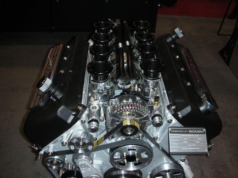 Top view of a Roush V8 engine with eight black individual throttle-body velocity stacks