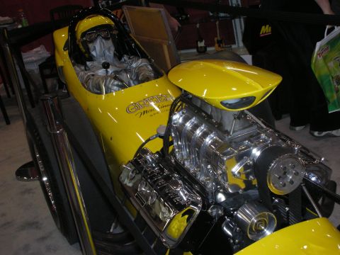 1998 Ford Crown Victoria - Yellow dragster with a suited mannequin in the seat and a chromed supercharged V8 with chrome side pipes.