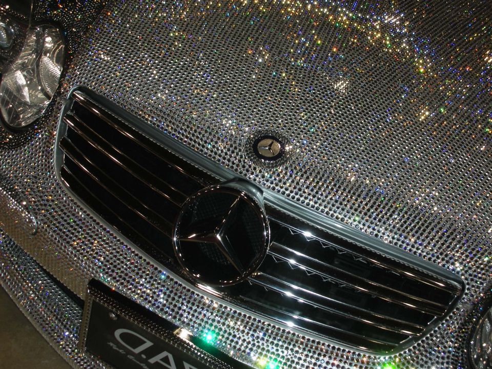 Close-up of a crystal-covered Mercedes-Benz front grille and three-pointed-star emblem