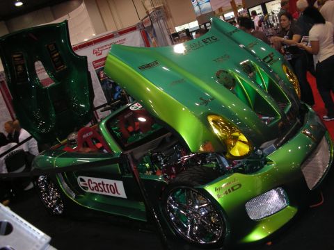 1998 Ford Crown Victoria - Green metallic custom show car with hood and door raised, exposing the engine bay and Castrol-stickered interior.
