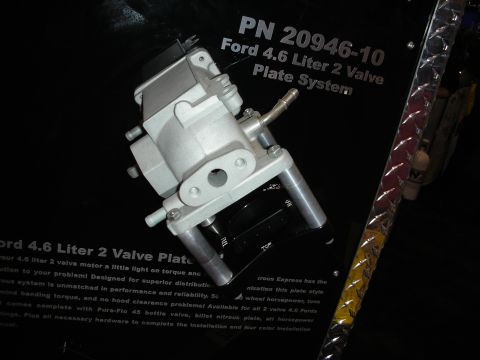 1998 Ford Crown Victoria - nitrous plate throttle-body component is displayed against signage reading PN 20946-10 Ford 4.6 Liter 2 Valve Plate System.