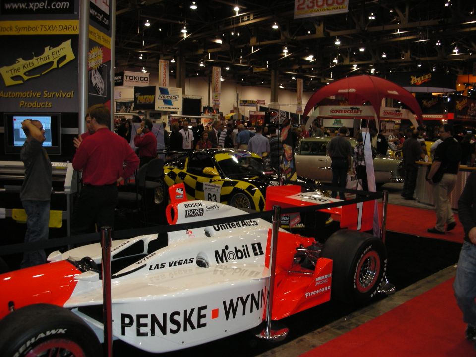 Red and white Penske Wynn's open-wheel race car on show display