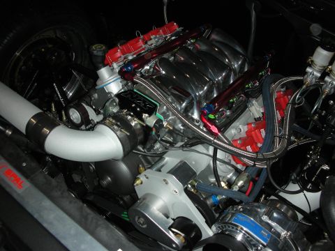 1998 Ford Crown Victoria - supercharged V8 with red fuel rails, braided lines and a polished intake is packed into a custom engine bay.