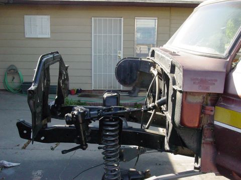 1979 Ford Bronco - Disassembled truck chassis and suspension components are visible in this photo.