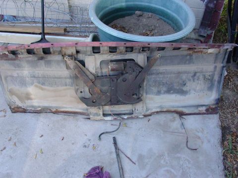 1979 Ford Bronco - The internal mechanism of a tailgate, showing significant rust and wear.