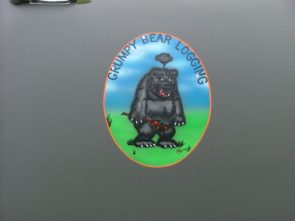Sticker of a grumpy cartoon bear with "GRUMPY BEAR LOGGING" text