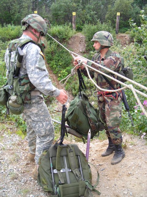 2003 Jeep TJ - Soldiers practice rappelling techniques with ropes and gear in an outdoor training area.