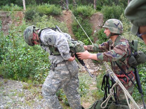2003 Jeep TJ - Soldiers participate in a training exercise involving ropes and rappelling equipment in a natural environment.