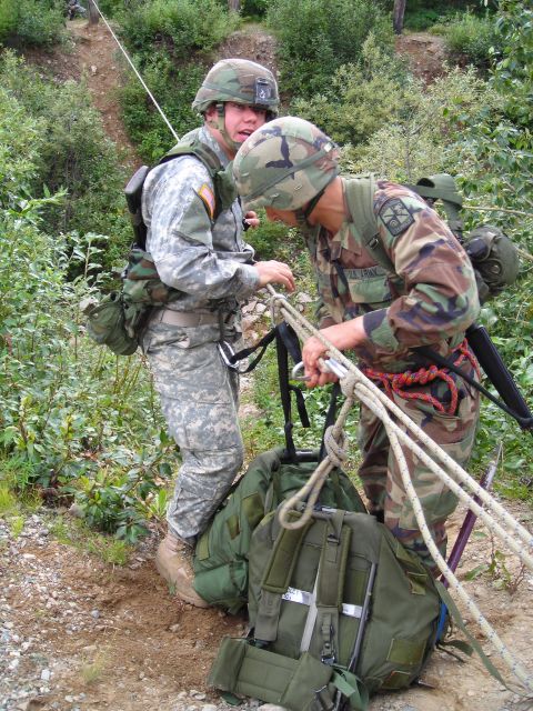 2003 Jeep TJ - Soldiers manage ropes and equipment on a steep, wooded slope during training.