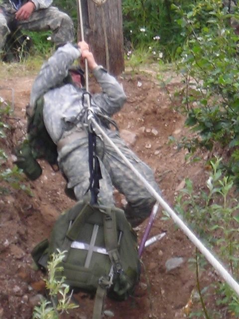 2003 Jeep TJ - Military personnel conduct rappelling training down a steep, wooded embankment.