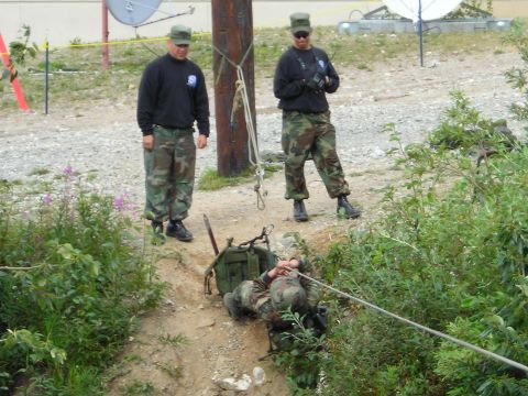 2003 Jeep TJ - Personnel practice rope rescue techniques during a training exercise, with observers present.