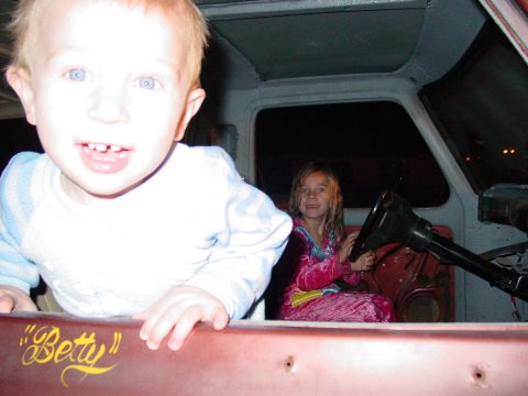 1979 Ford Bronco - Two children are inside a vehicle, one in the driver's seat and another in the foreground.