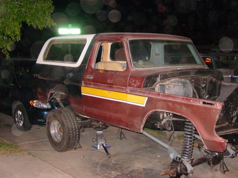 1979 Ford Bronco - This 1979 Ford Bronco is undergoing repairs, with its front end disassembled and the vehicle supported by jacks.