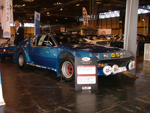 2001 Ford Fiesta - A blue sports car with racing decals and auxiliary lights is displayed indoors, with other vehicles visible in the background.