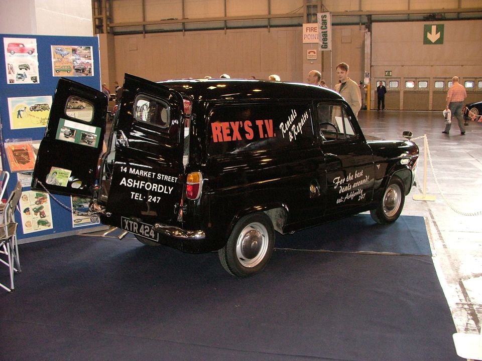 black van with REX'S T.V. Rentals & Repairs on side, address and phone number on back door