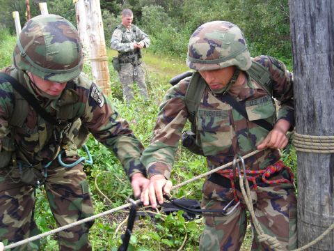 2003 Jeep TJ - Military personnel train in rappelling techniques, with one soldier's name tag clearly visible as 'FUENTES'.