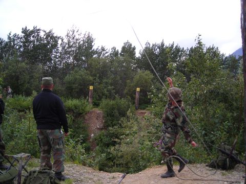 2003 Jeep TJ - Military personnel engage in rope training with targets in an outdoor, wooded environment.