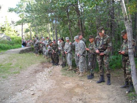 2003 Jeep TJ - A group of soldiers in camouflage uniforms are lined up outdoors, holding ropes and appearing to prepare for an activity.